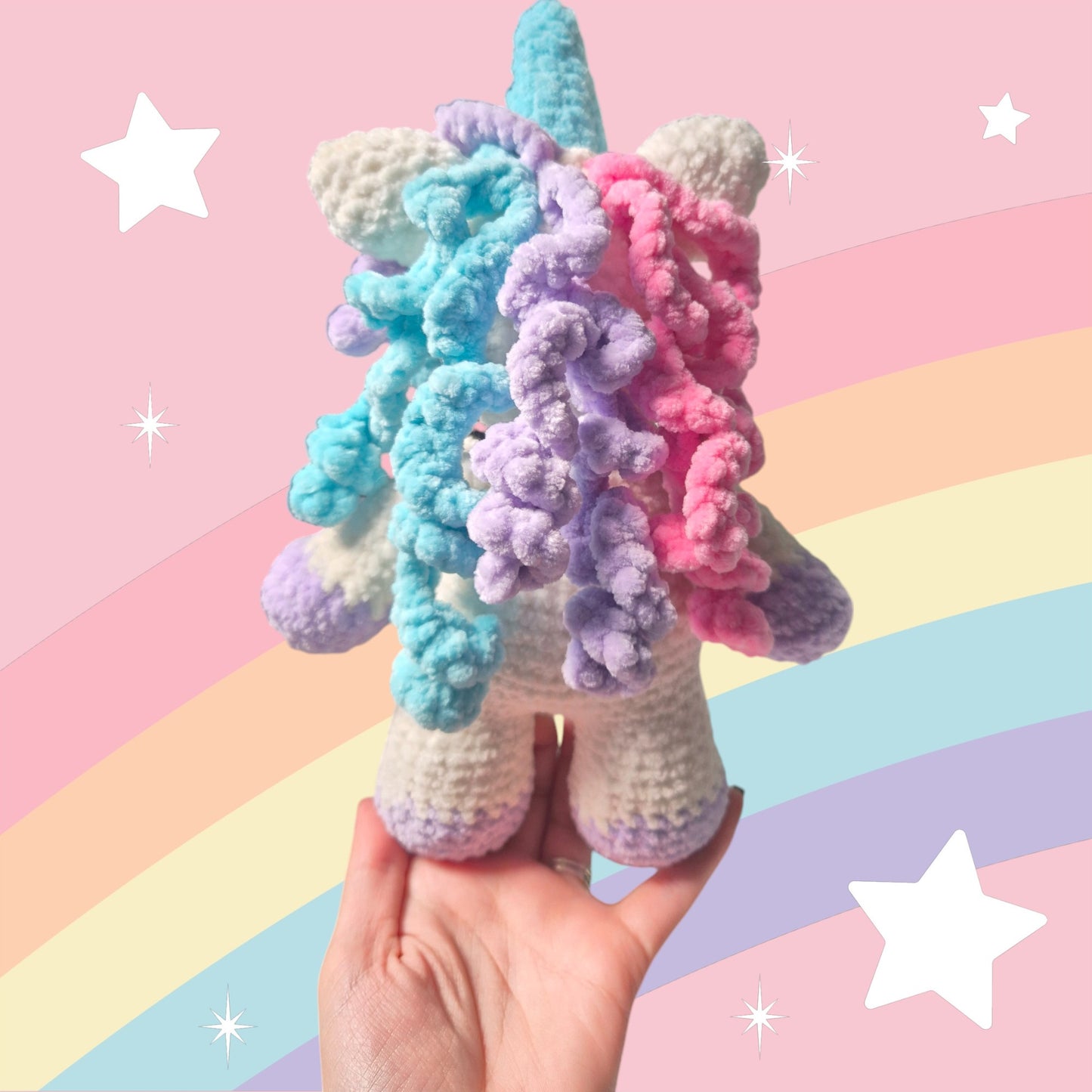 Crocheted unicorn soft toy with curly hair