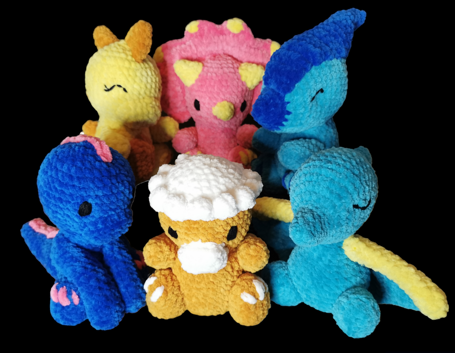 A group of 6 crocheted dinosaur soft toys in bright colours