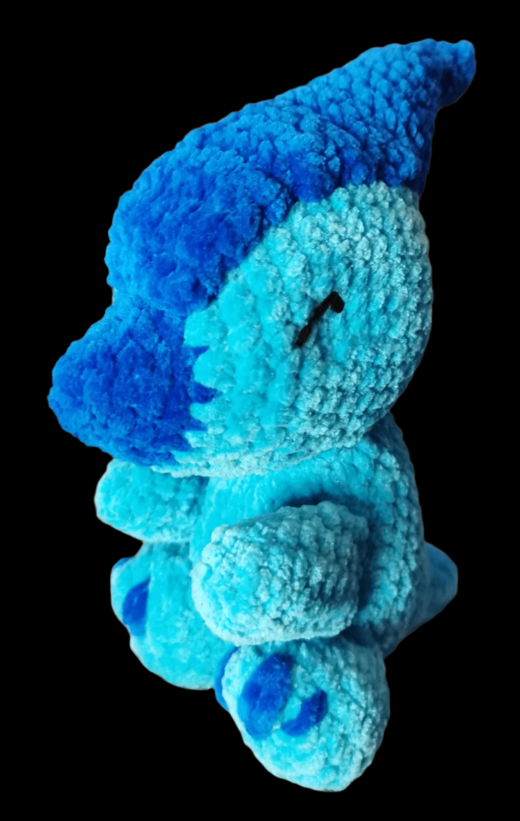 A blue crocheted Parasauralophus soft toy