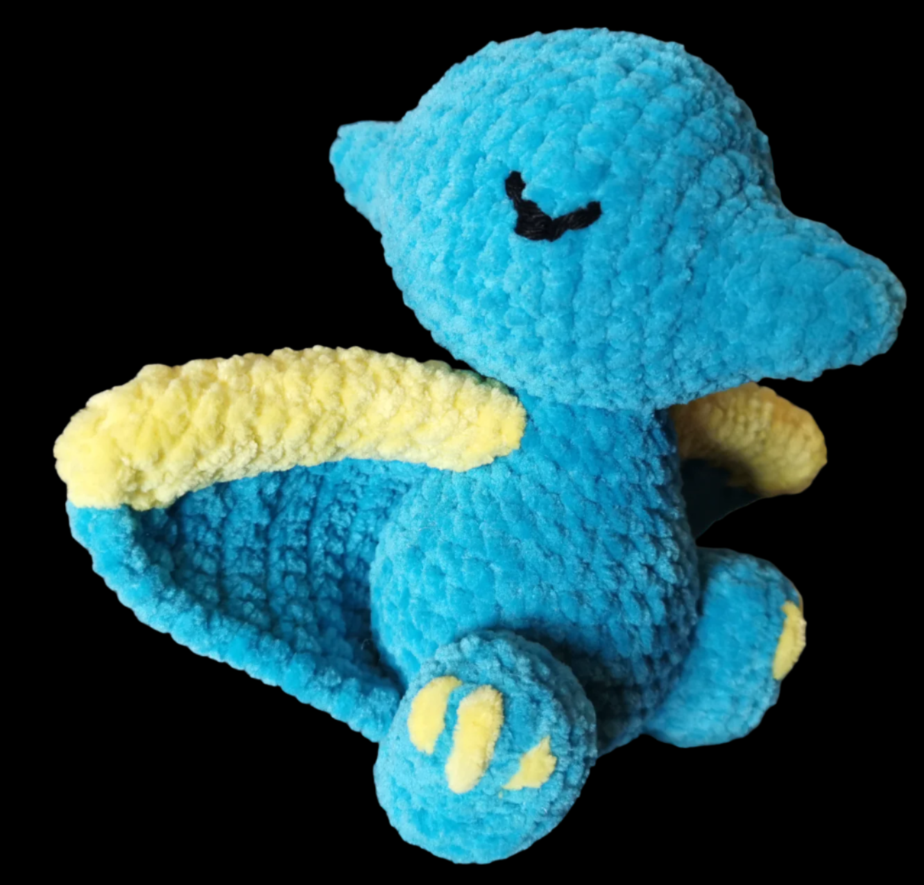 A blue crocheted Pterodactyl soft toy