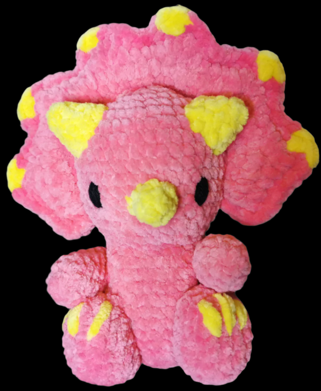 A pink crocheted Triceratops soft toy