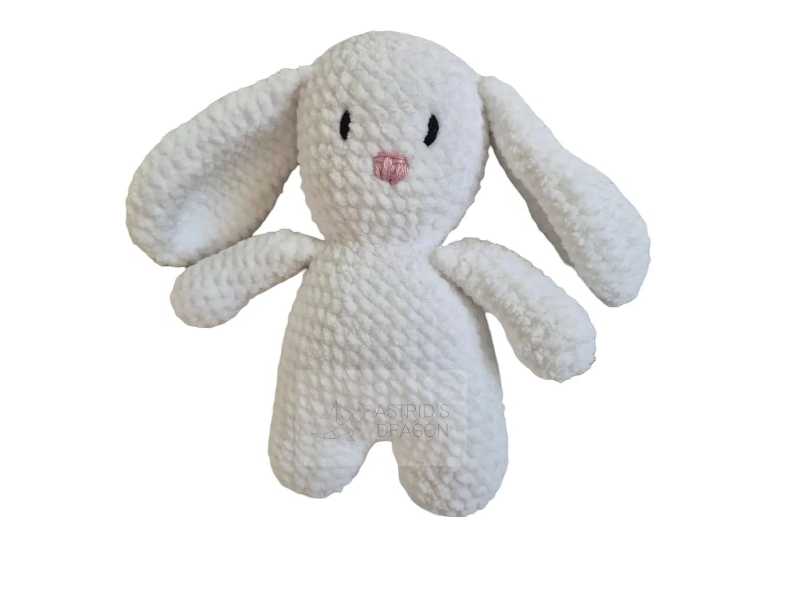 A white crocheted bunny with a pink nose